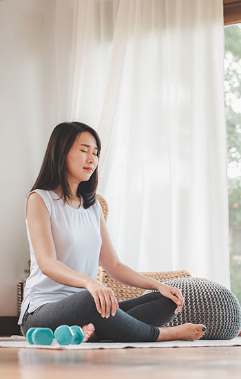 Asian woman doing yoga meditation at home Woman doing yoga in her home